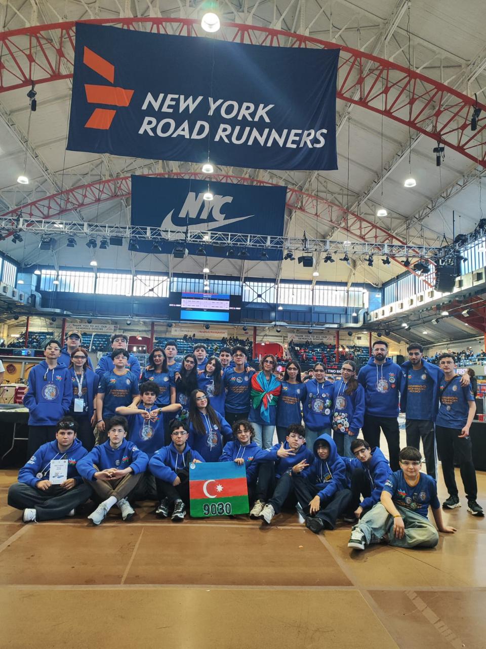 Qarabağ MecHack 9030 full team photo at the FRC New York City Regional, holding the Azerbaijan flag and team number 9030 sign